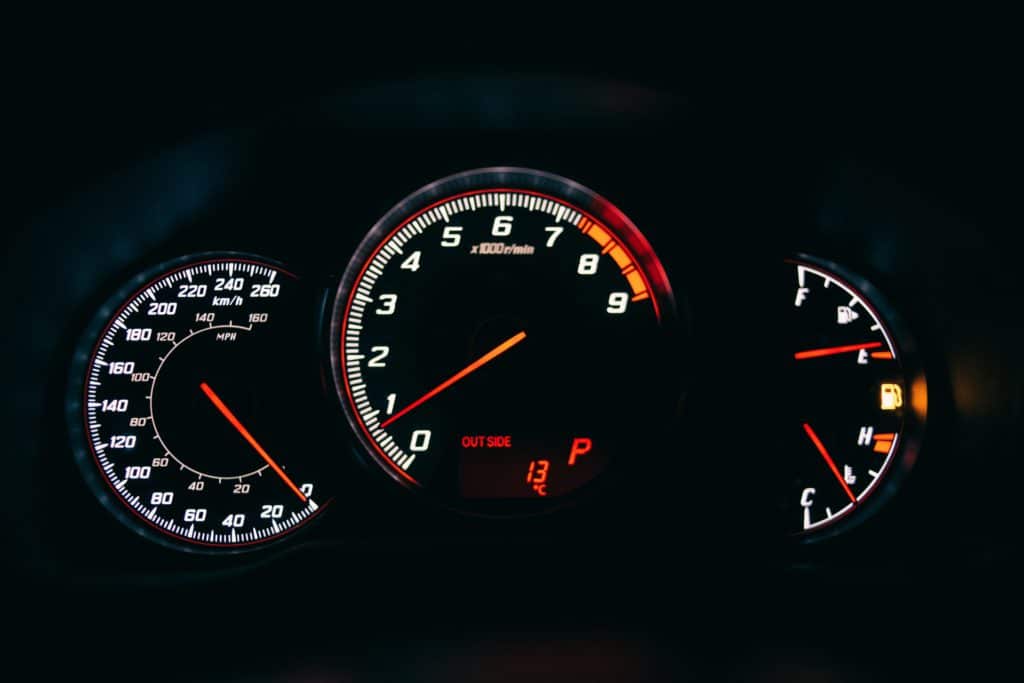a car instrument cluster showing empty fuel gauge