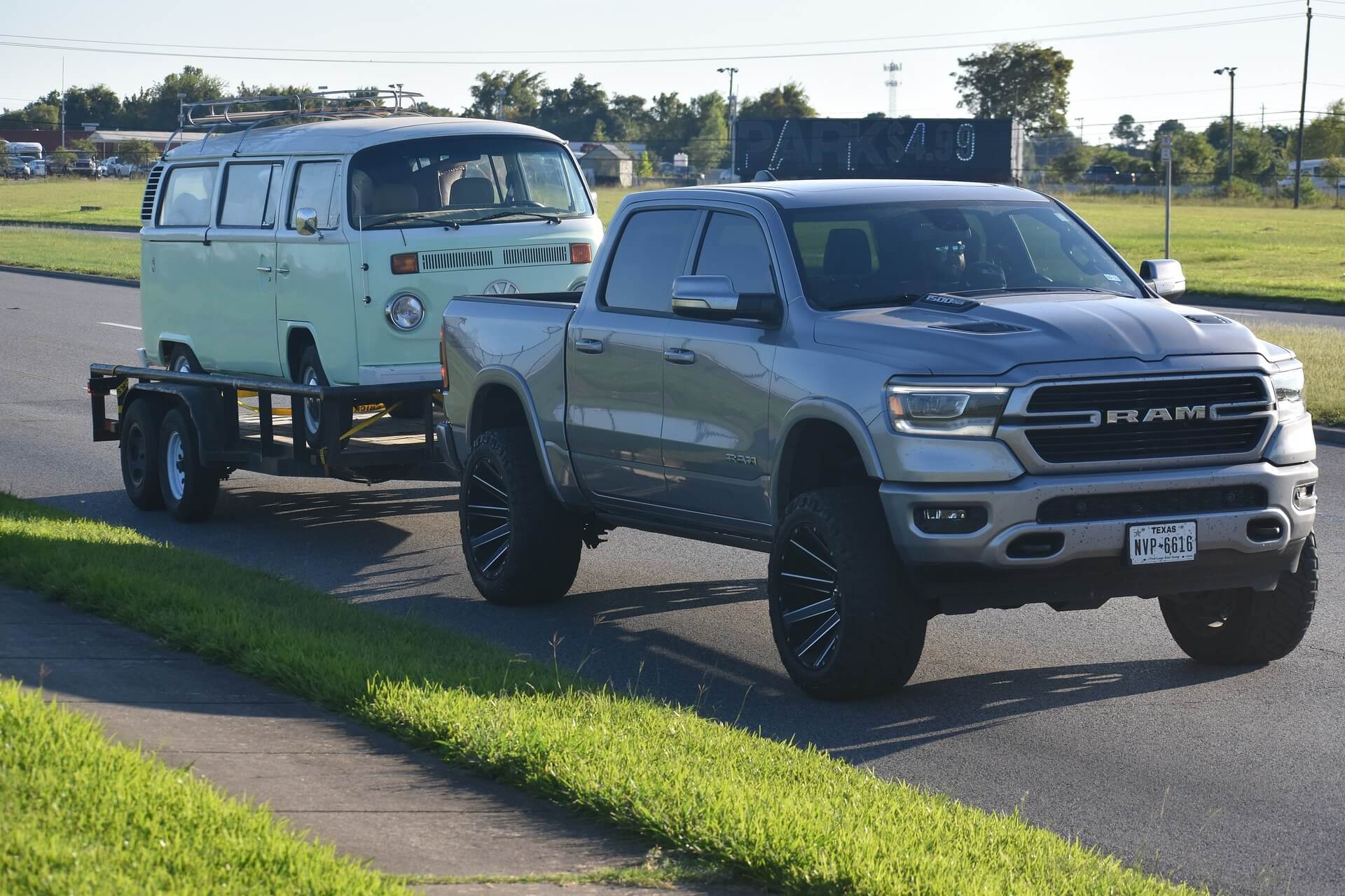 a ram pick up towing a volkswagen