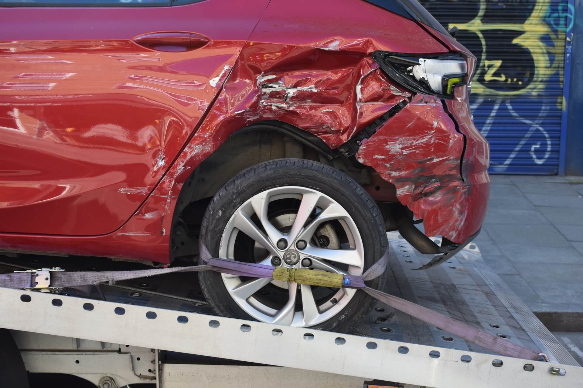 a red car in a towing truck