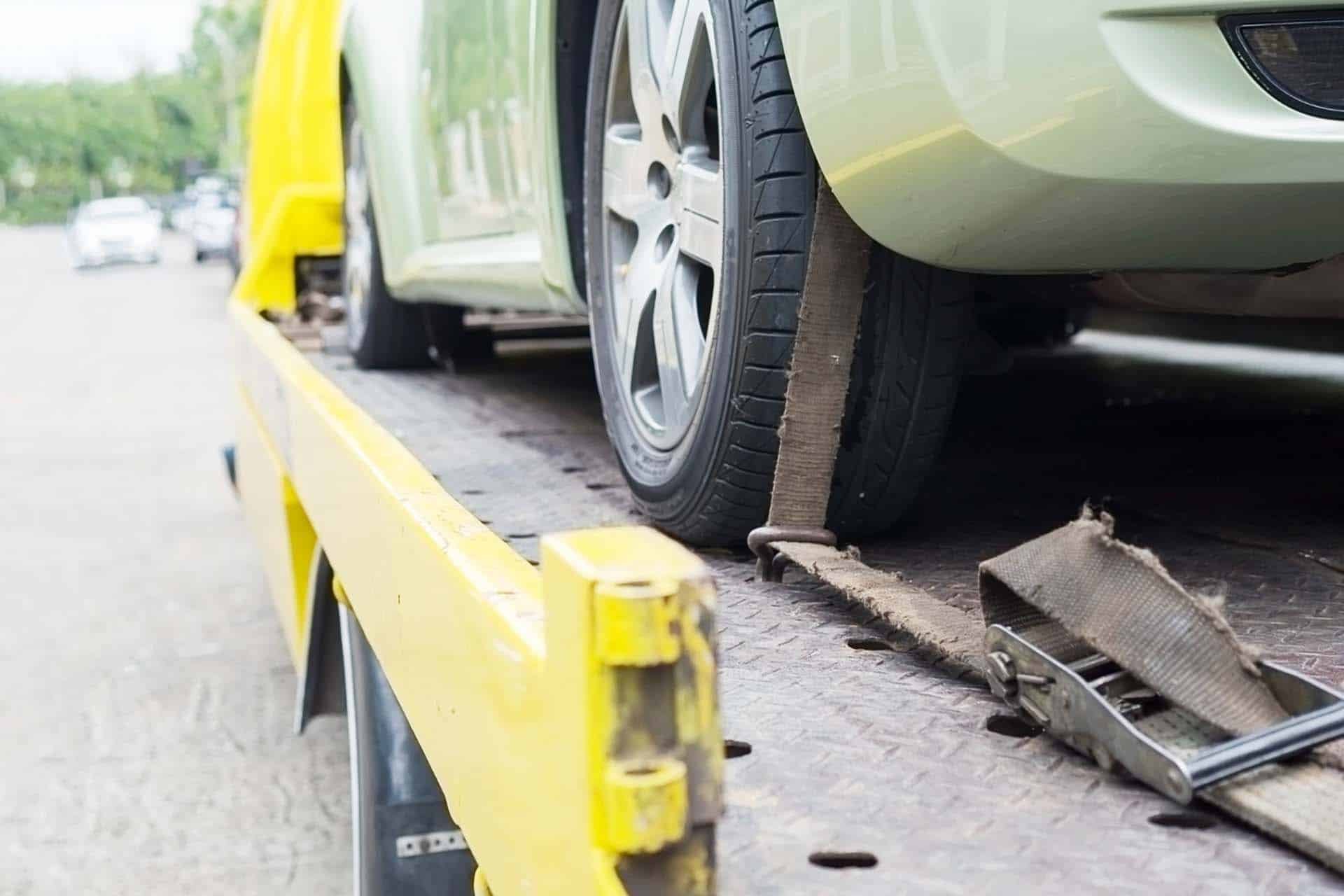 a yellow car being towed