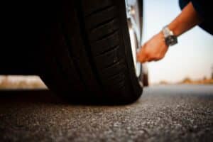 a person checking flat tire