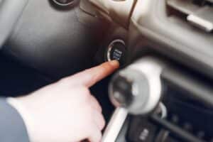 a person trying to start a car with bad ignition switch